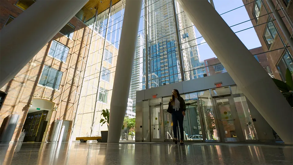 Woman walking to work through buildings lobby